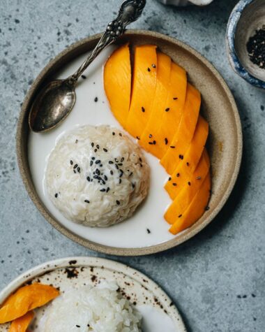 Traditional Thai mango sticky rice with black sesame seeds topping